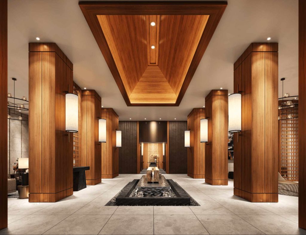 Luxury condominium lobby with warm wood columns, soft lighting, and a central water feature
